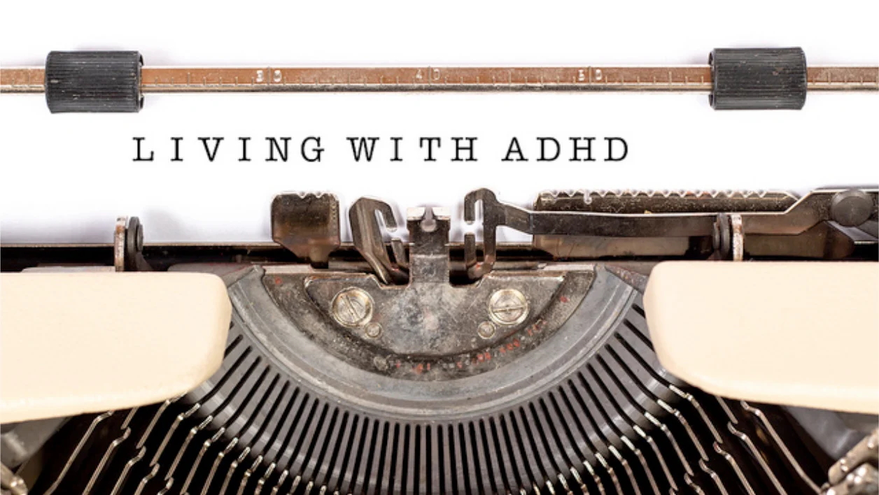 an old manual typewriter displaying the word Living with ADHD