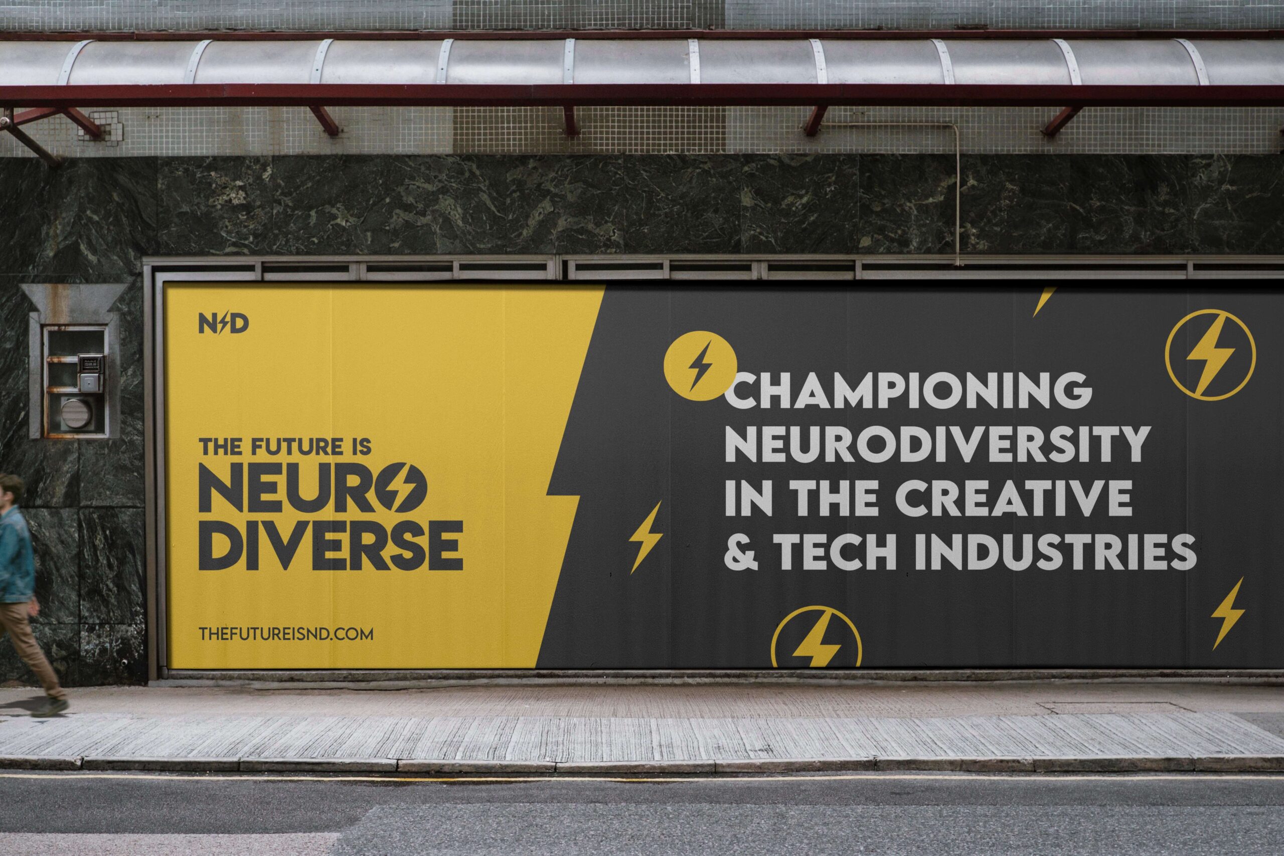 Bold city billboard with text reading 'The Future is Neurodiverse' on a yellow background and 'Championing Neurodiversity in the Creative & Tech Industries' on a black background, with lightning bolt icons. TheFutureIsND.com URL is displayed at the bottom.